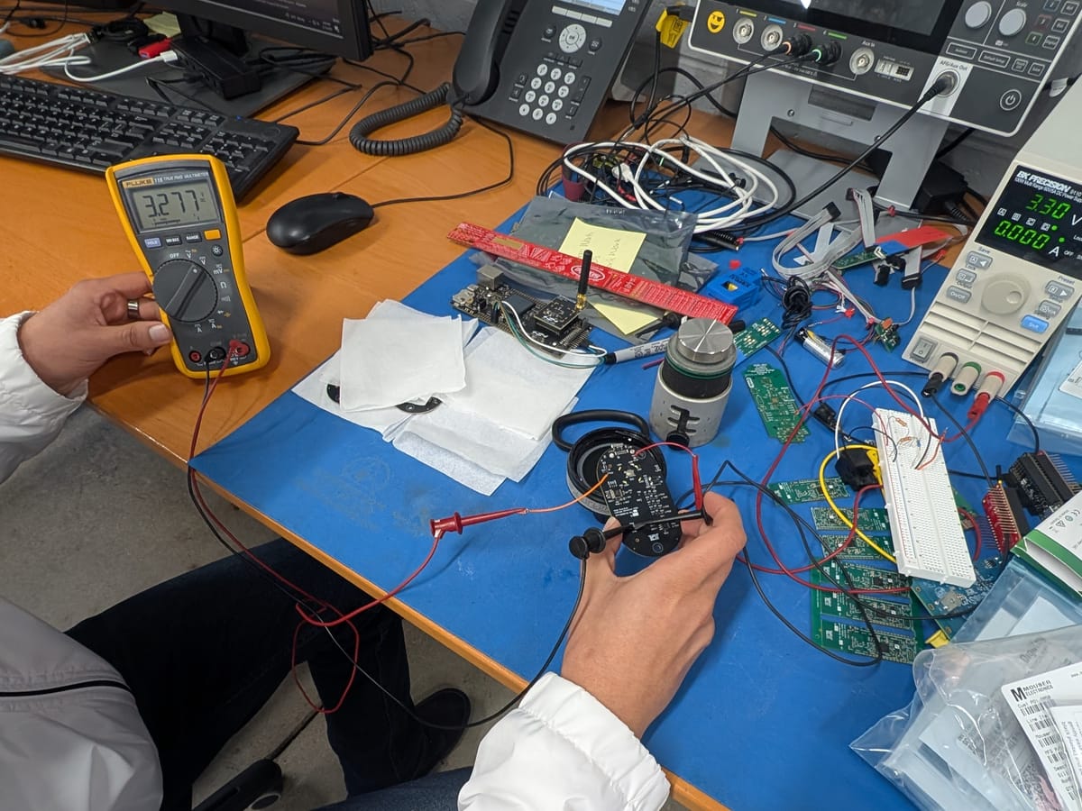 Engineer debugging a circuit board at an electronics bench